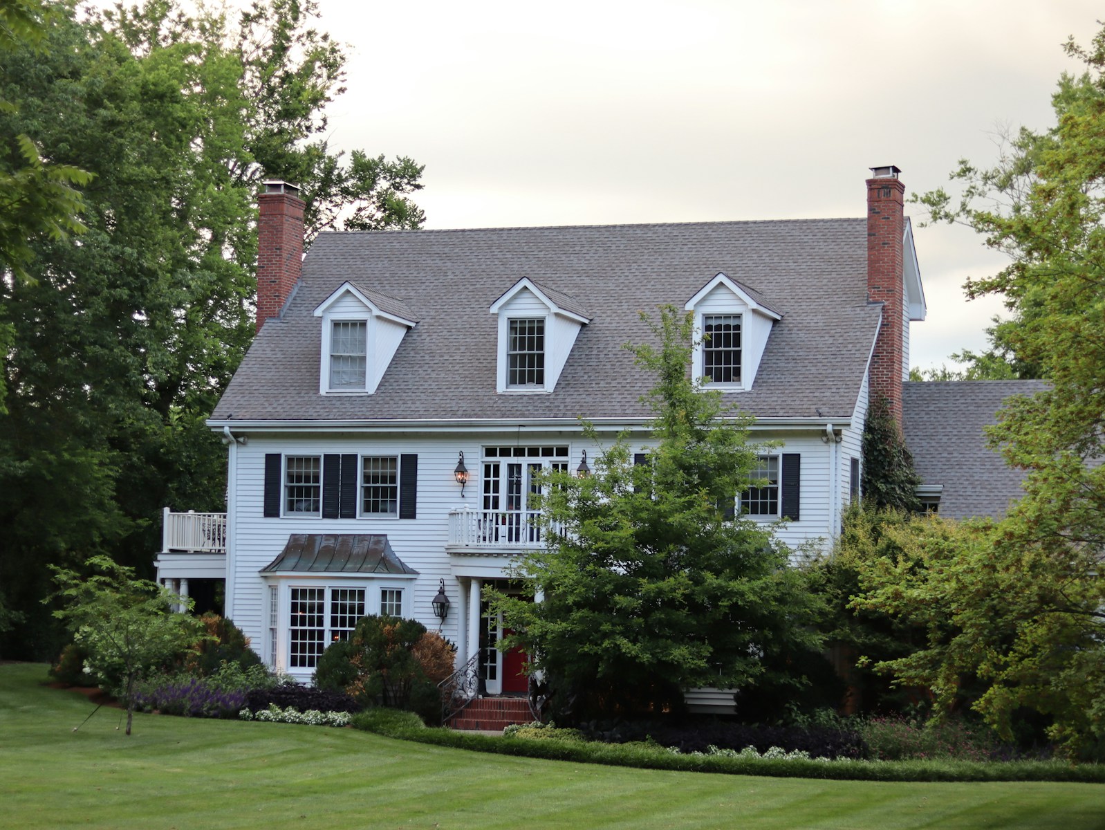 a large white house with black shutters and windows