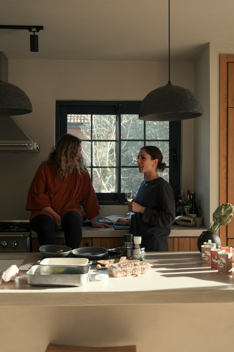 Two women talking in a modern kitchen