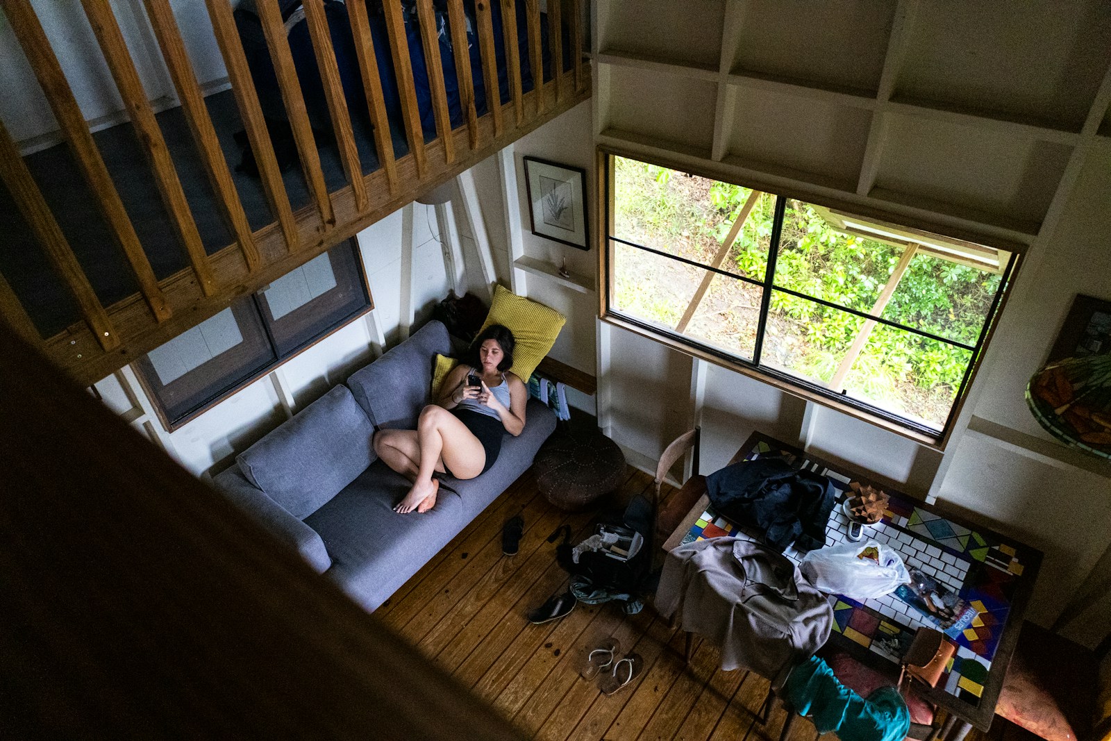 Woman relaxes on a couch inside a cozy cabin