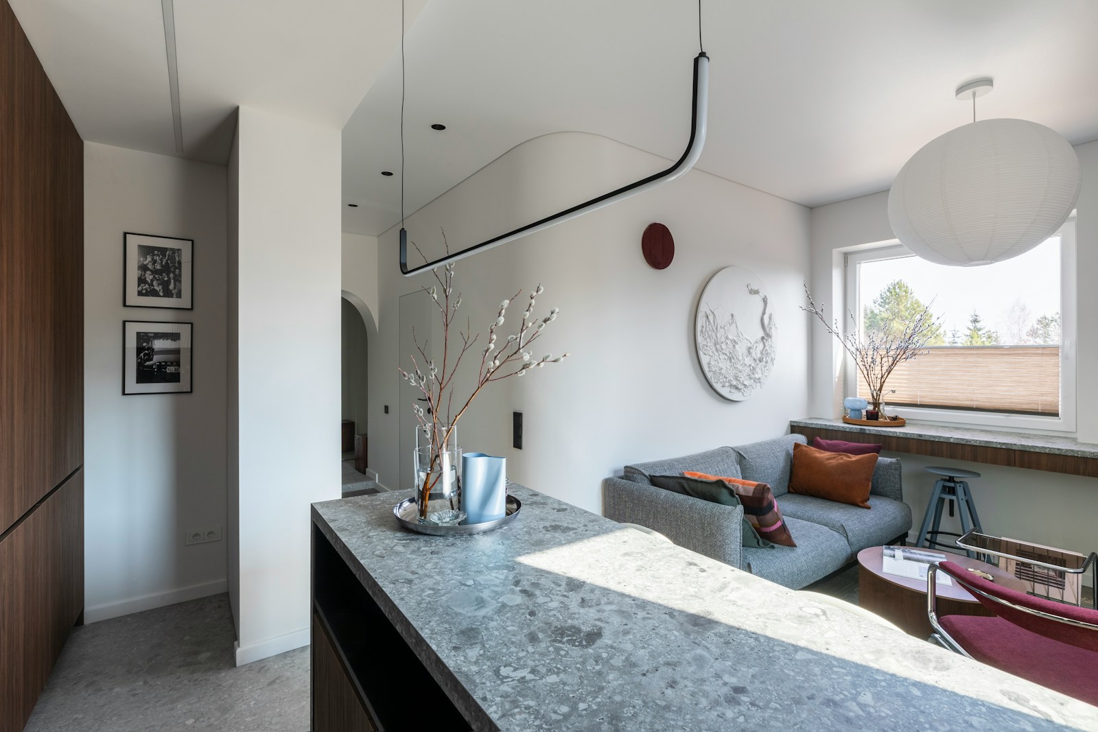 Contemporary living space featuring a sofa and stone counter