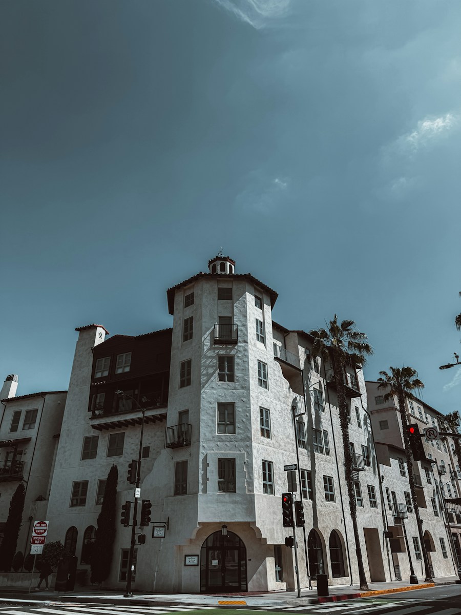 a tall white building sitting on the side of a road