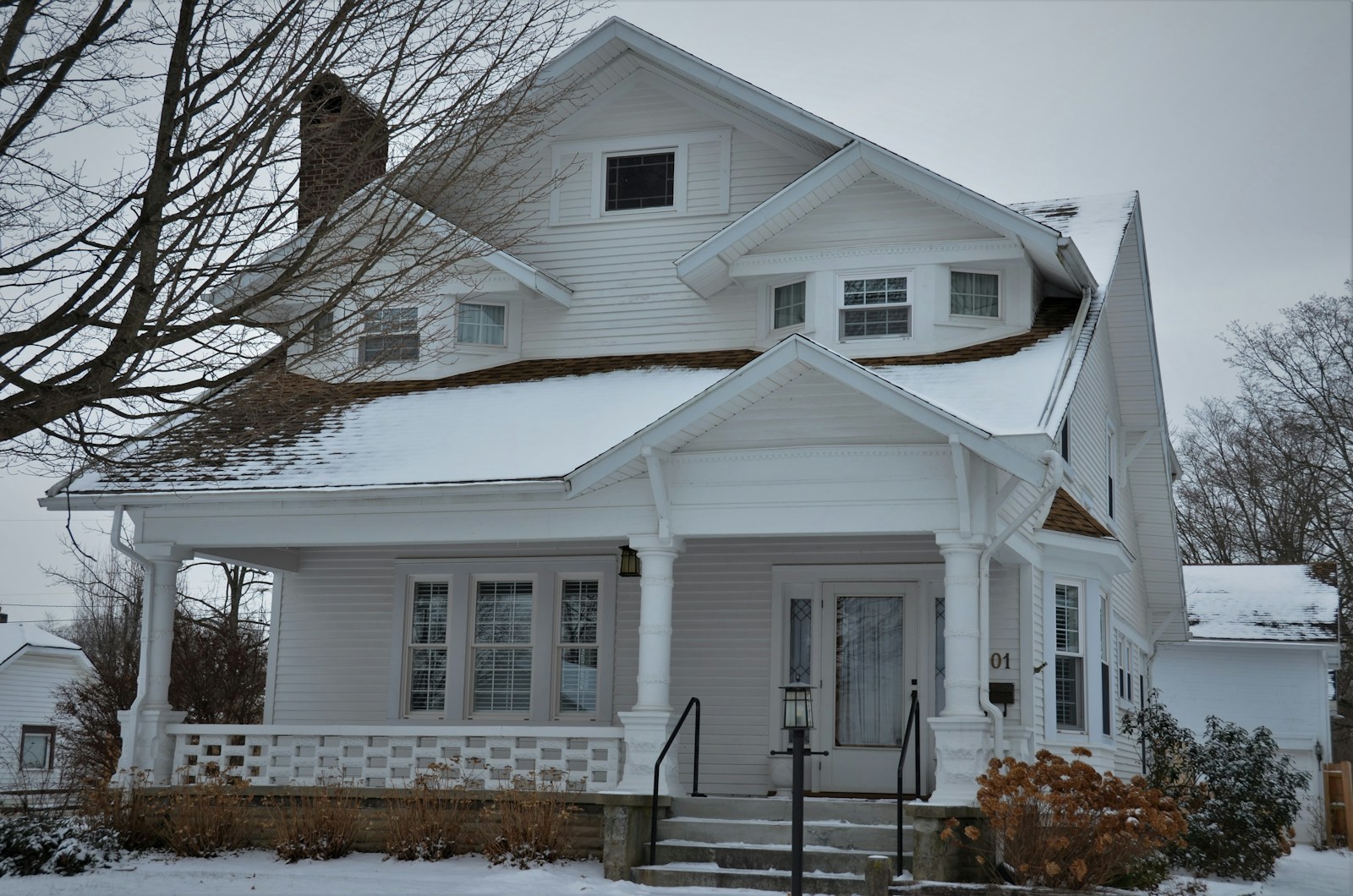 a white house with a steeple covered in snow