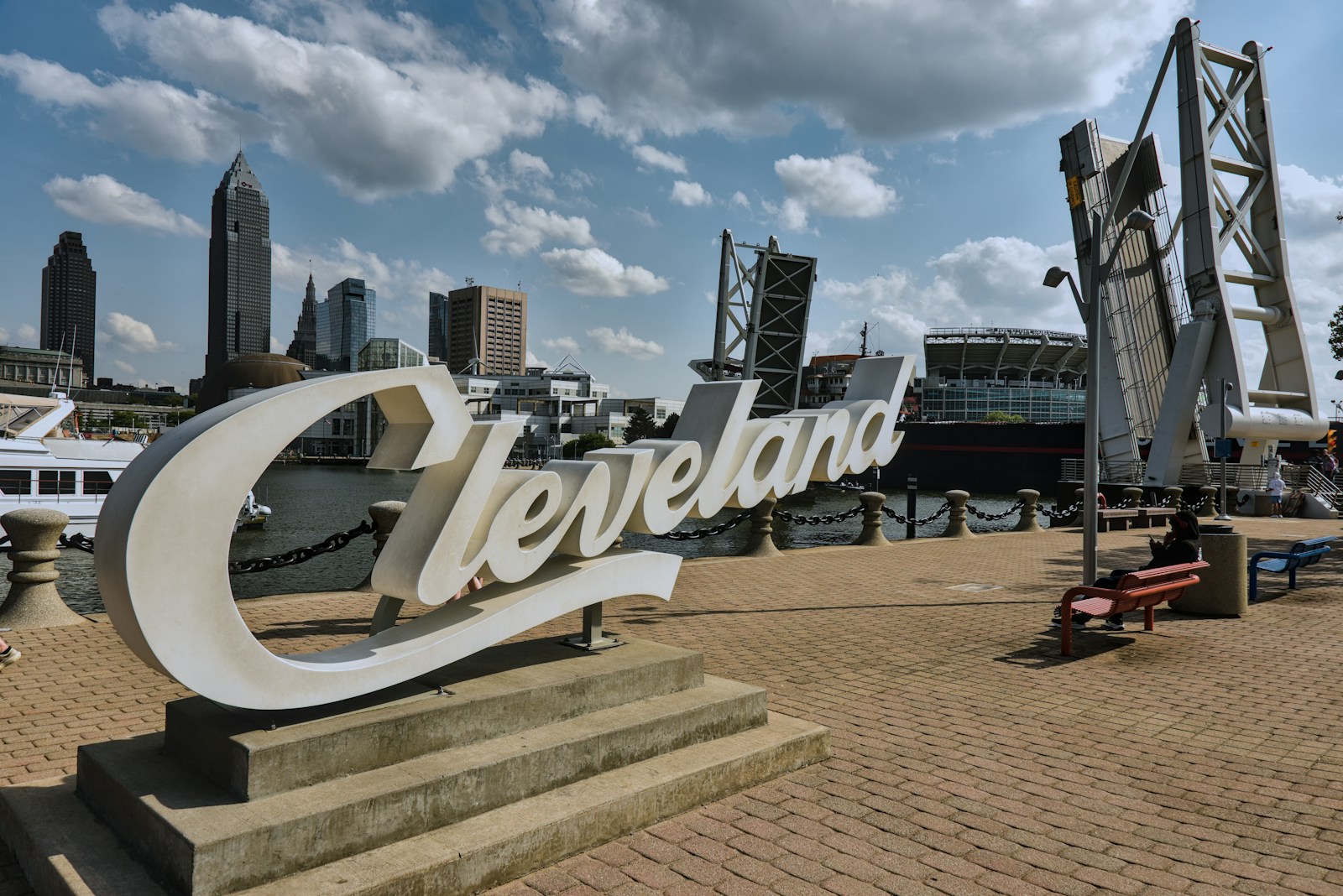 Cleveland sign by waterfront with city skyline and drawbridge