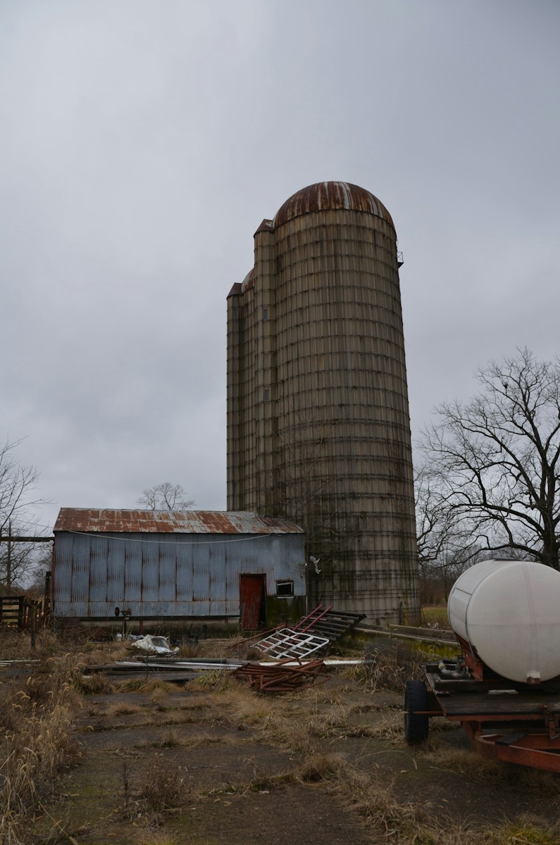 a large silo sitting next to a building