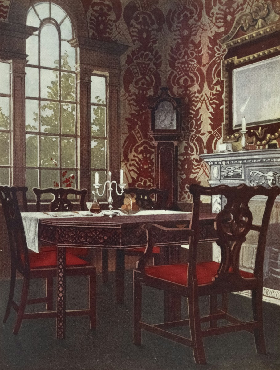 Elegant dining room with antique furniture and wallpaper