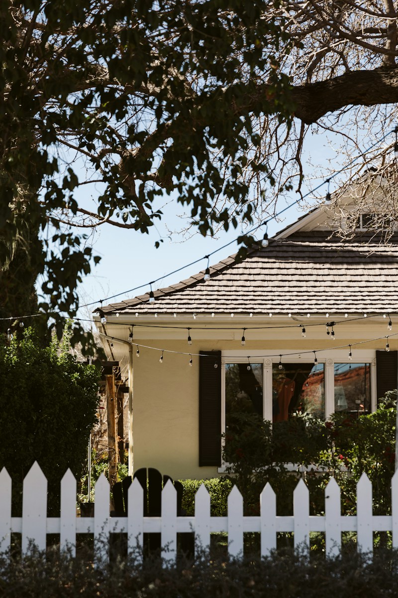 a white picket fence in front of a house