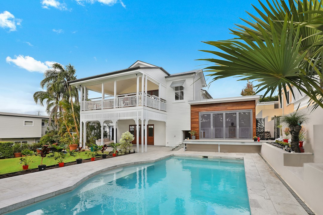 Backyard swimming pool behind a house