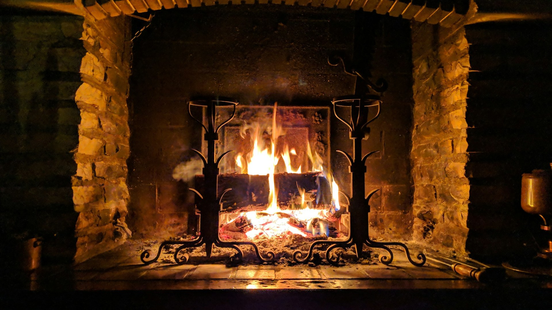 A fire burning in a fireplace. Photo by Stéphane Juban on Unsplash.