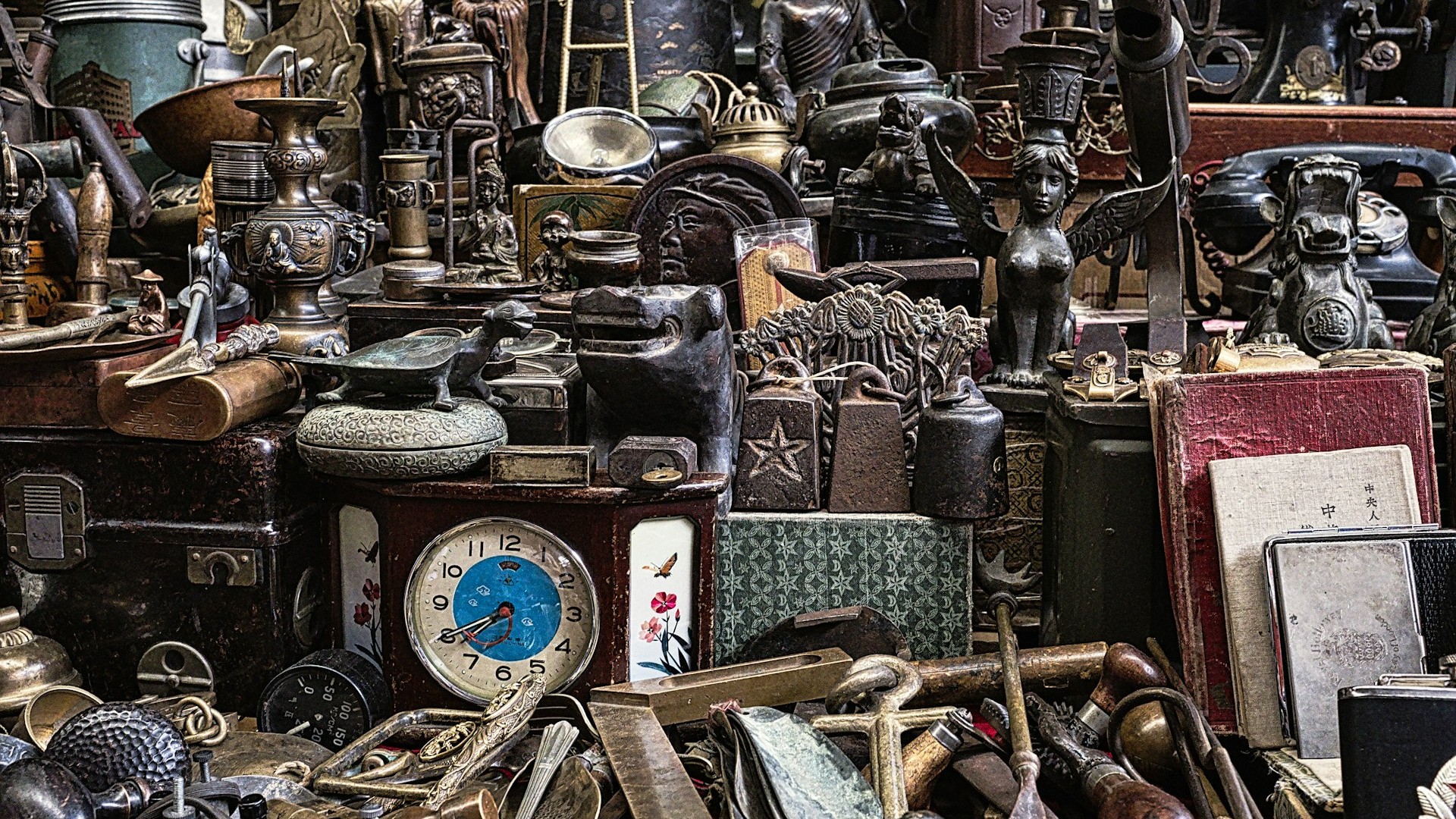 Unsplash photo by Eric Prouzet showing shelves of antiques in a small shop: vintage clocks, figurines and metal trinkets