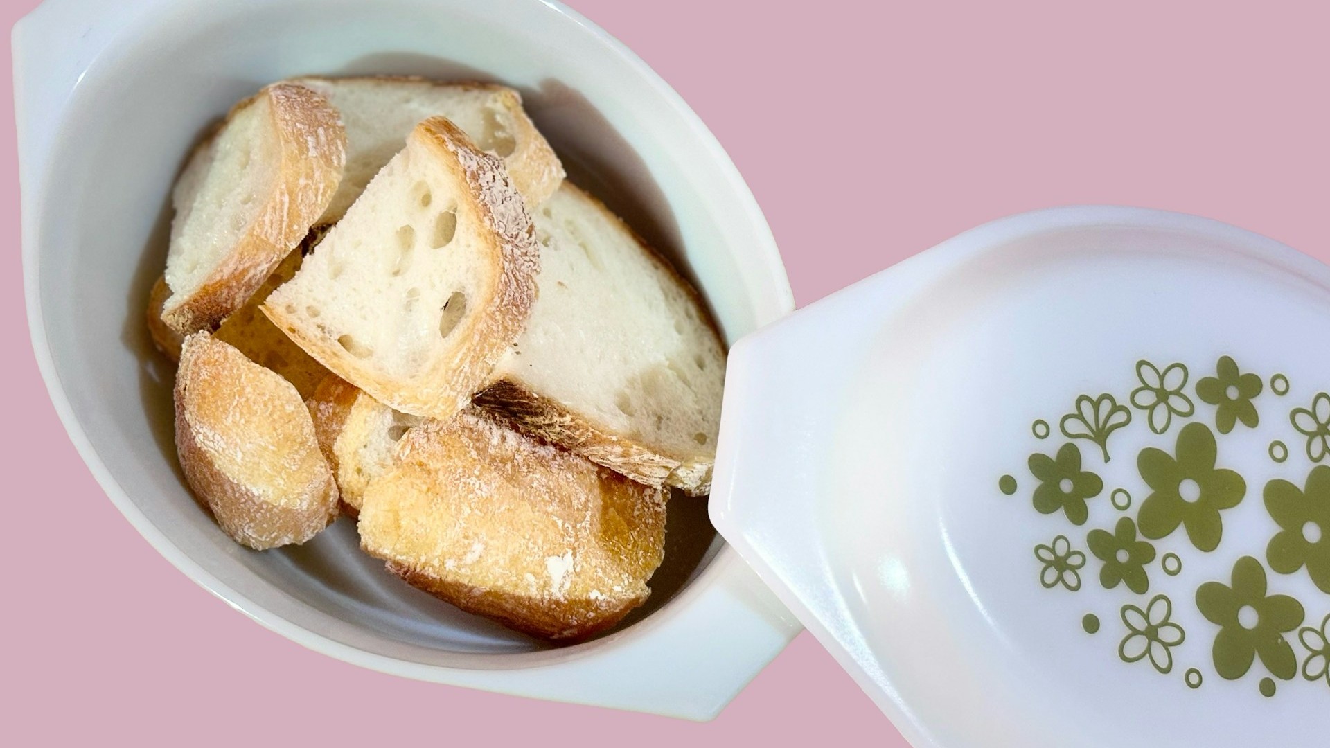 Unsplash photo by OHLUCINDA showing pieces of bread in a white bowl beside a vintage floral Pyrex bowl on a pink surface