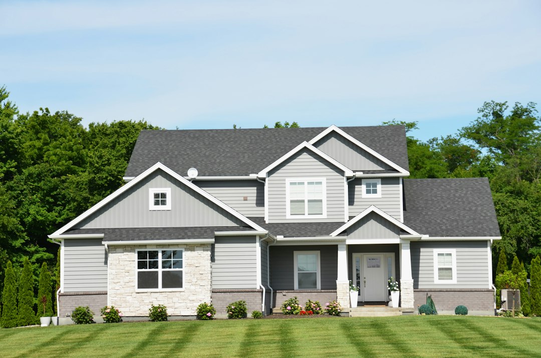 Modern grey house with a green lawn and landscaping