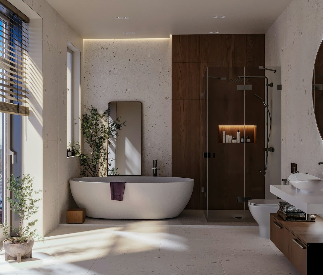 Modern bathroom with tub, sink and large window