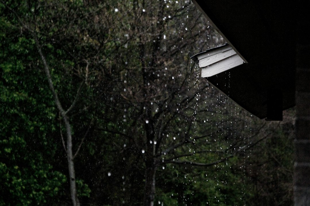 Rain dripping from a house roof after a storm
