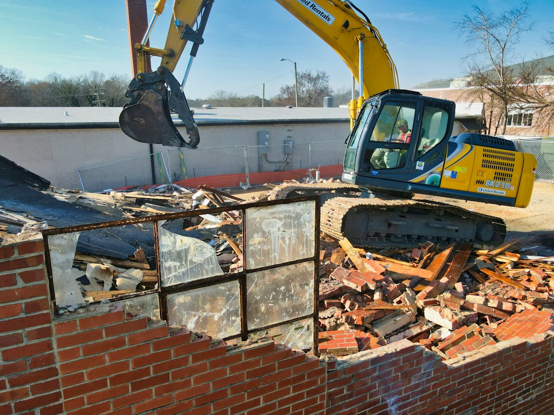 Construction worker tearing open a wall